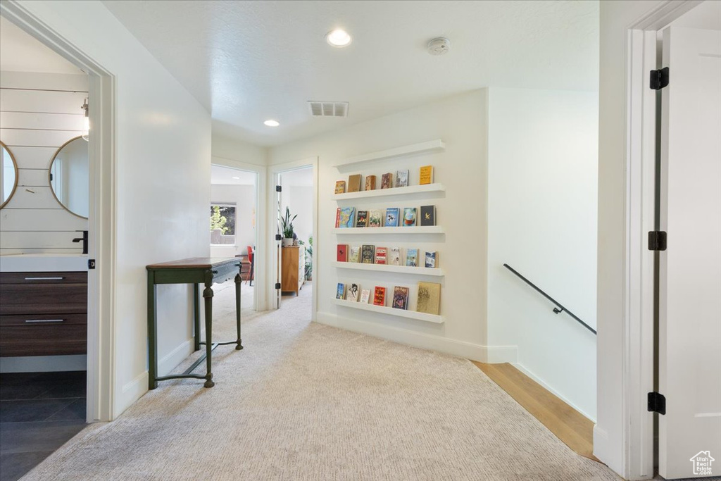 Hallway featuring an upstairs landing, recessed lighting, and carpet flooring