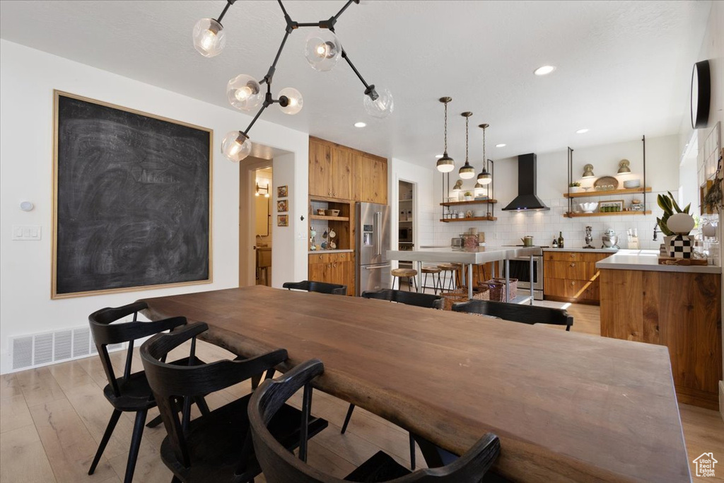 Dining room featuring light wood-style flooring and recessed lighting