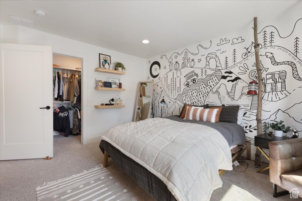 Carpeted bedroom with a walk in closet, a closet, and recessed lighting