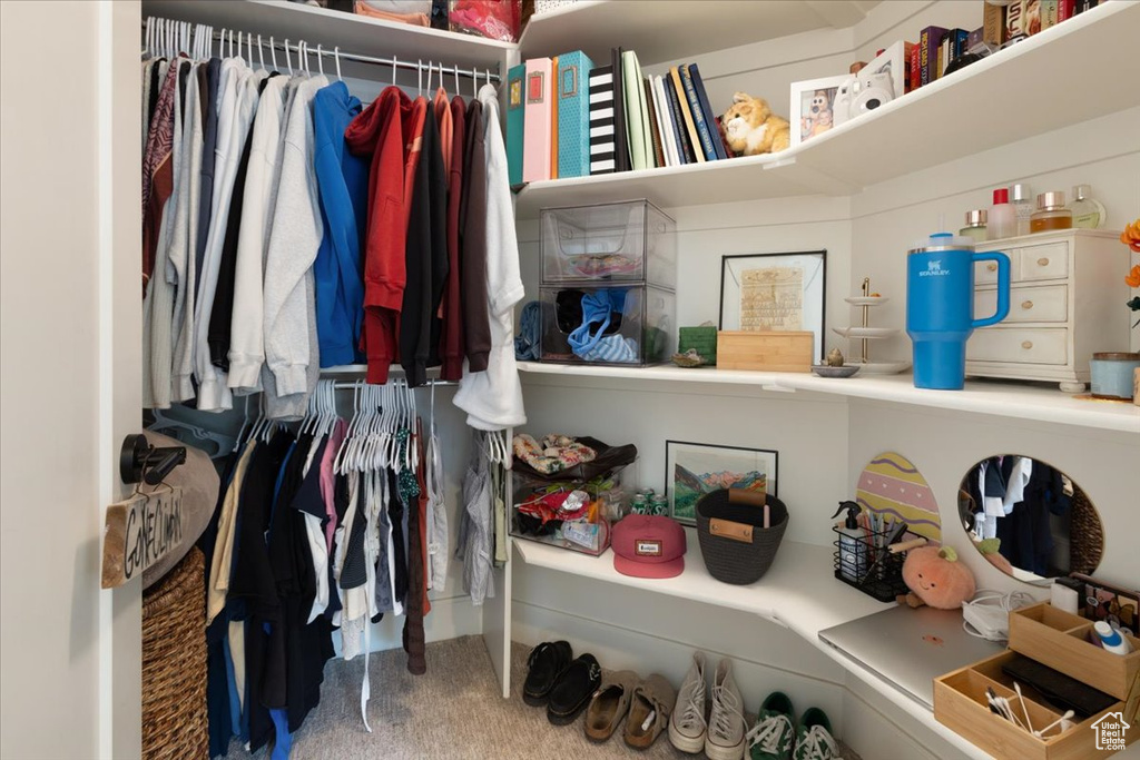 Spacious closet featuring carpet flooring