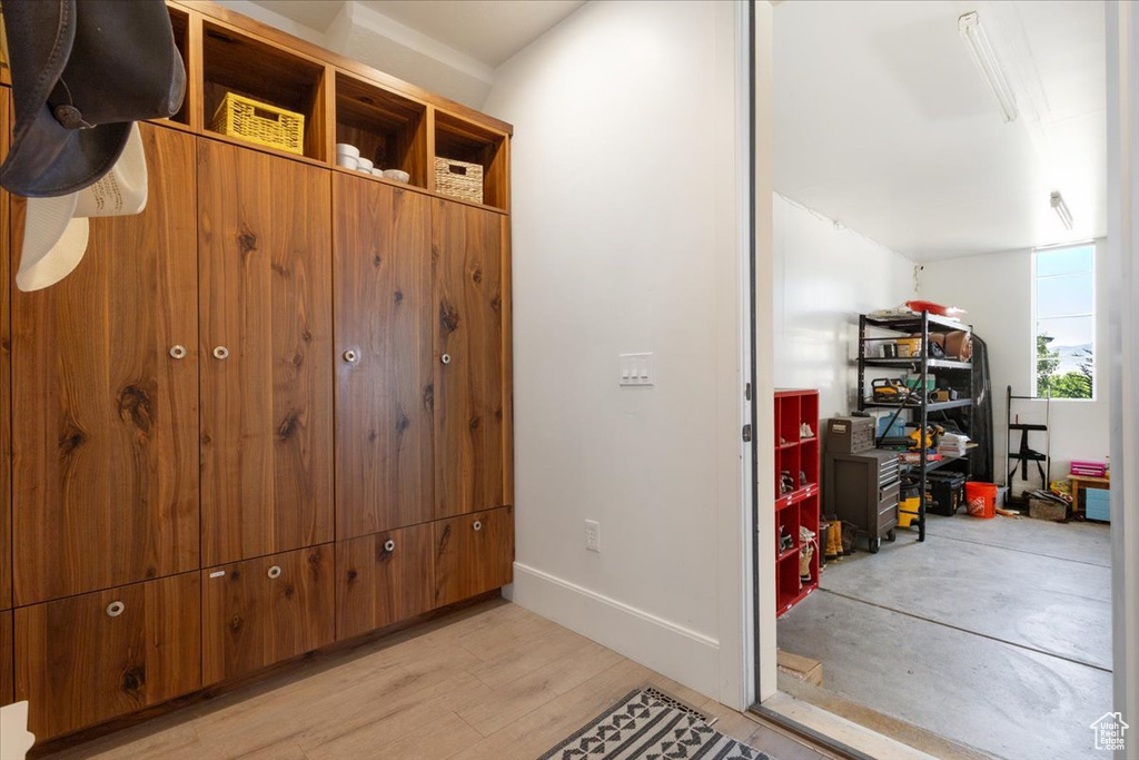 Mudroom with light wood-style floors and baseboards