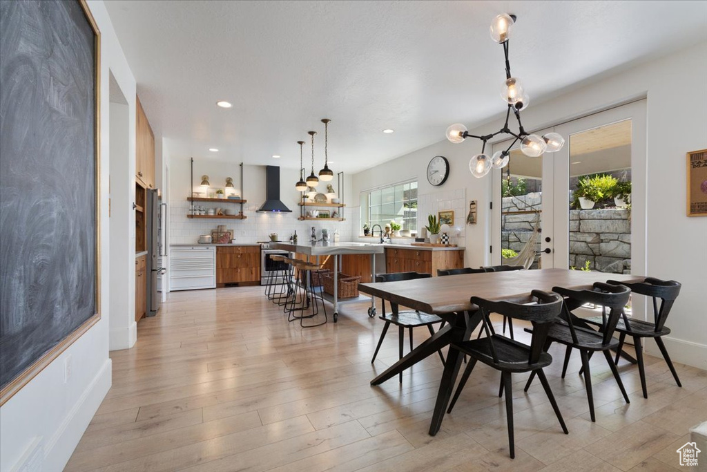 Dining space featuring a chandelier, recessed lighting, and light wood-type flooring