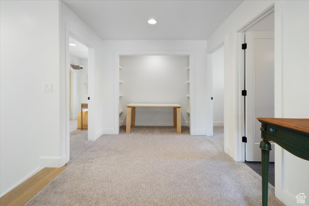 Hallway with recessed lighting and carpet