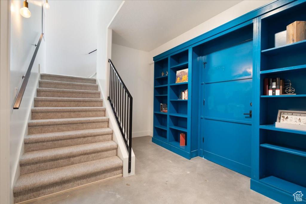 Stairs featuring concrete floors