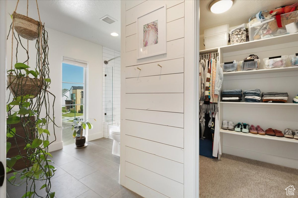 Spacious closet featuring tile patterned flooring