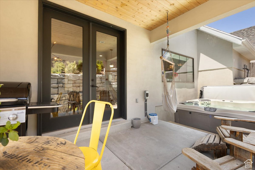 View of patio with a hot tub