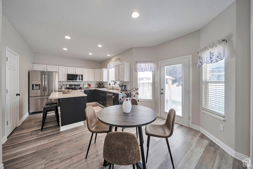 Dining space featuring light wood-type flooring and recessed lighting