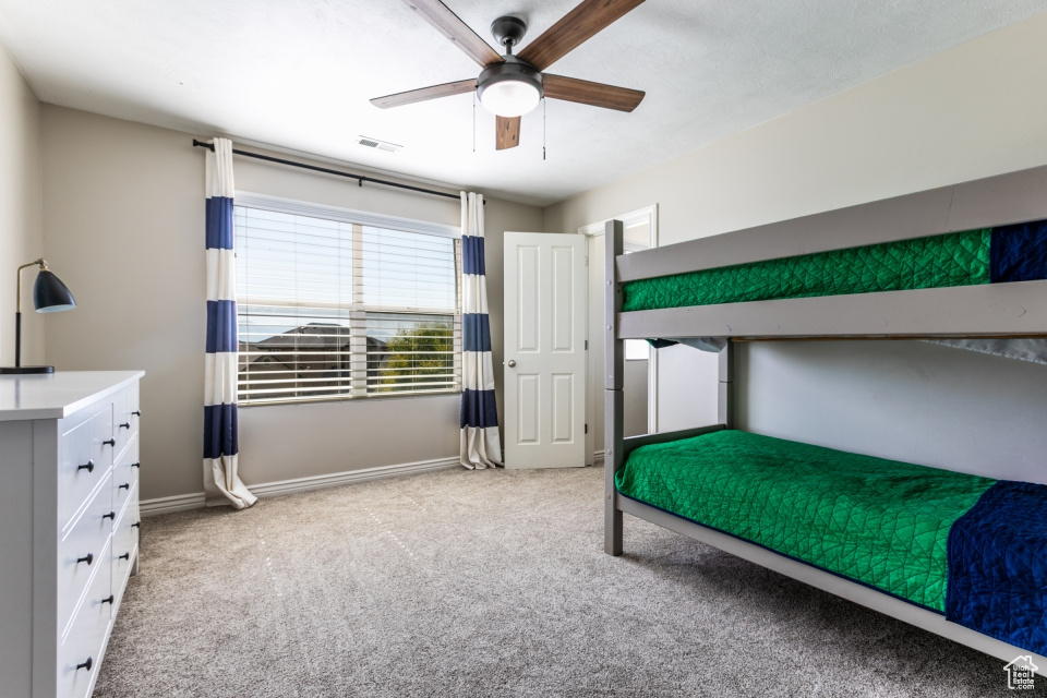 Unfurnished bedroom featuring carpet and a ceiling fan