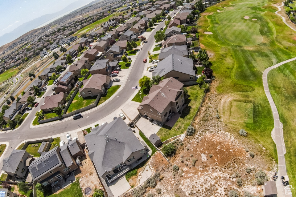 Aerial overview of property\'s location featuring nearby suburban area, a golf club, and a mountain backdrop
