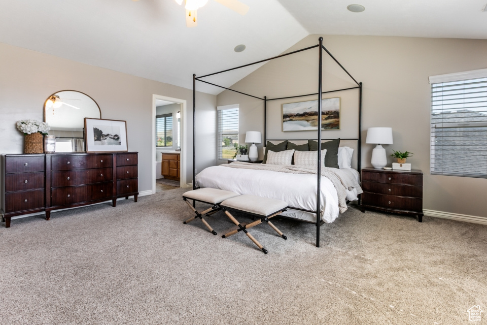 Bedroom with lofted ceiling, carpet, ensuite bathroom, and ceiling fan