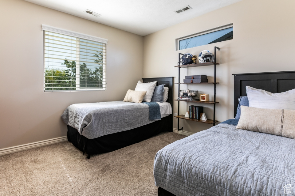 Carpeted bedroom featuring baseboards