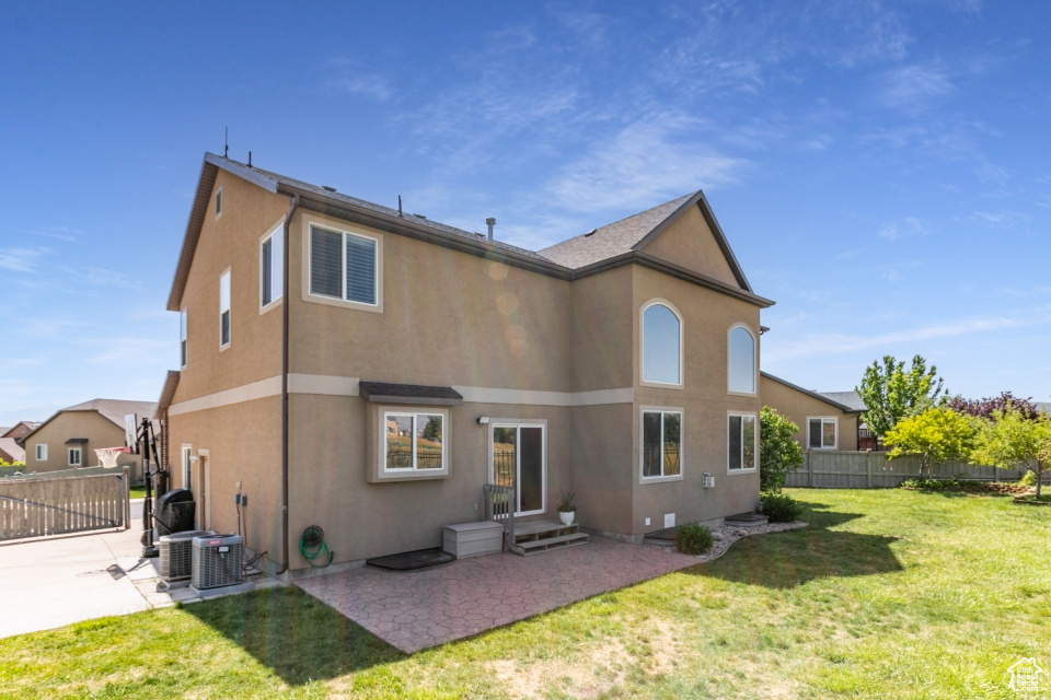 Back of house featuring a patio and stucco siding