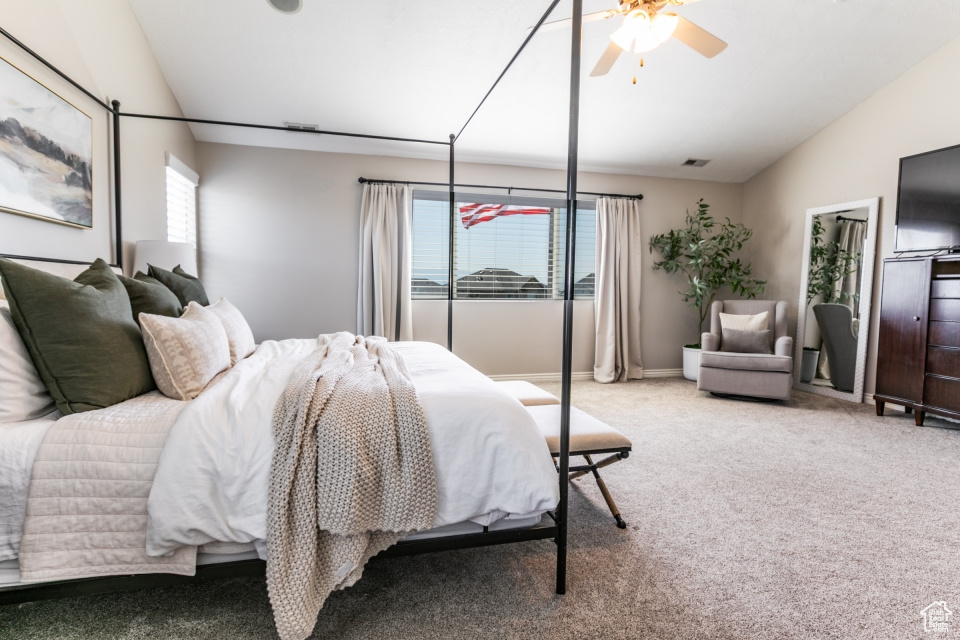 Bedroom featuring lofted ceiling, carpet, and a ceiling fan