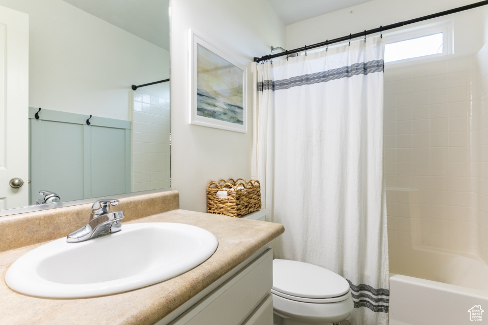 Full bath with vanity and shower / bath combination with curtain