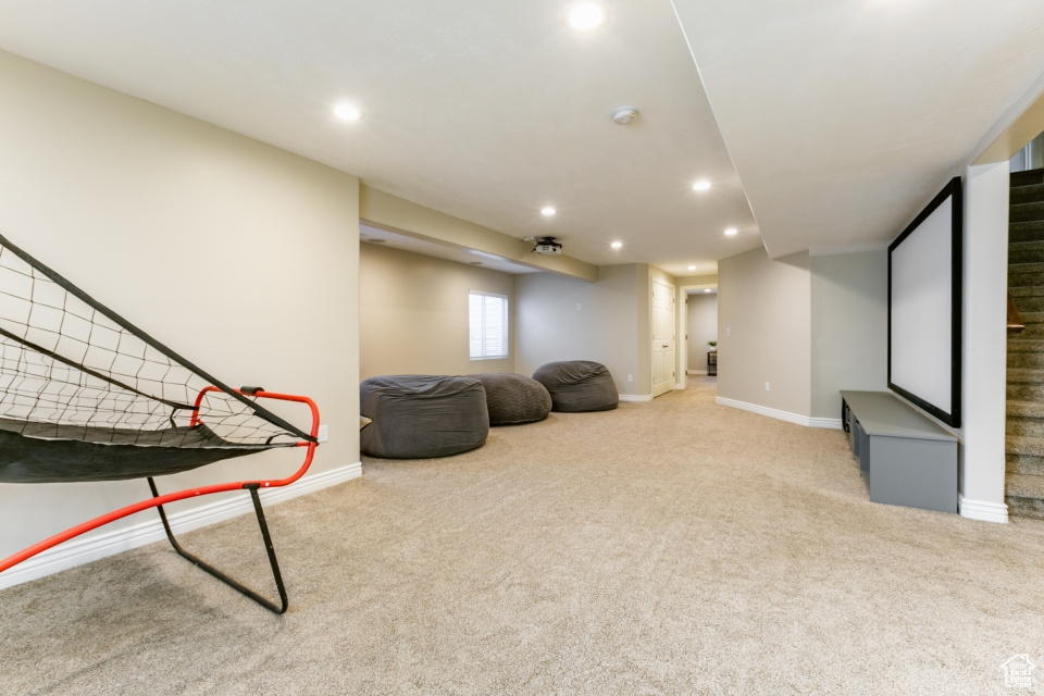 Rec room with light carpet and recessed lighting