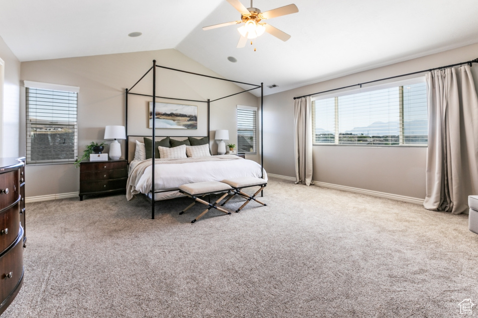 Bedroom with carpet, lofted ceiling, and a ceiling fan