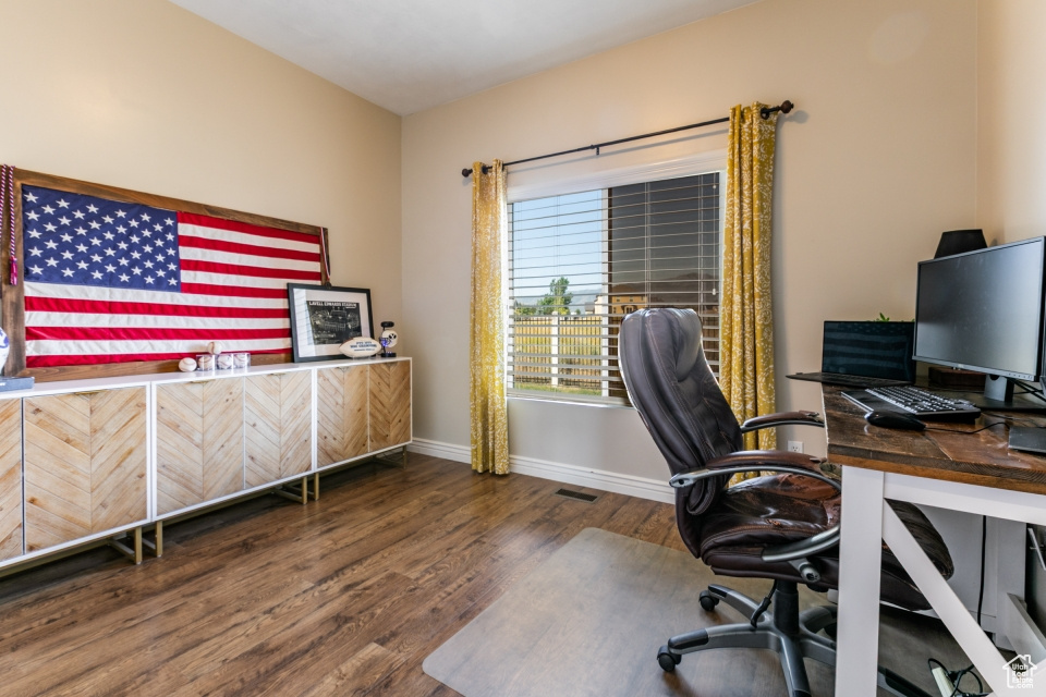 Office space with wood finished floors and bar