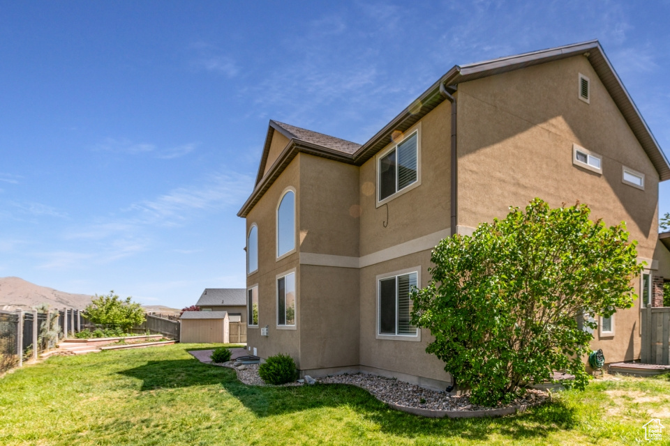 View of property exterior featuring stucco siding and a garden