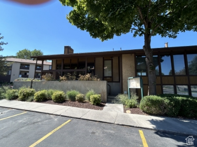 View of building exterior featuring uncovered parking