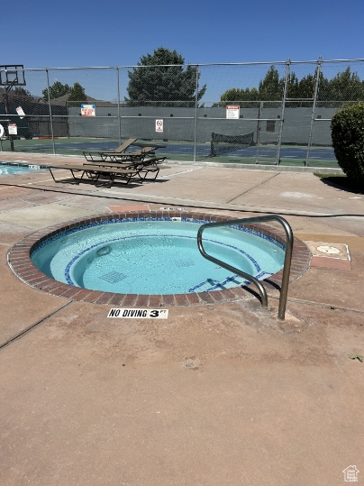 View of swimming pool with a hot tub and a swimming pool