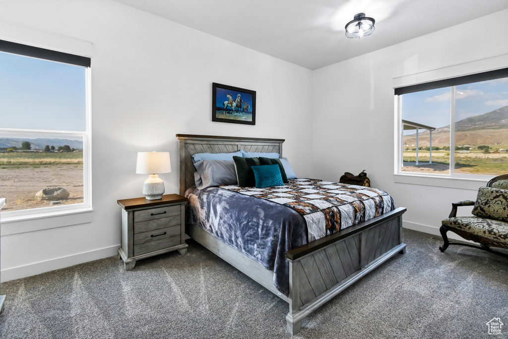 Bedroom featuring carpet flooring and a mountain view