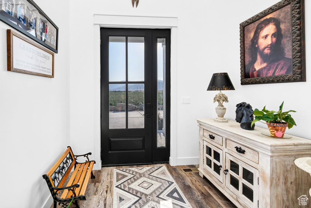 Foyer featuring dark wood-style floors and baseboards