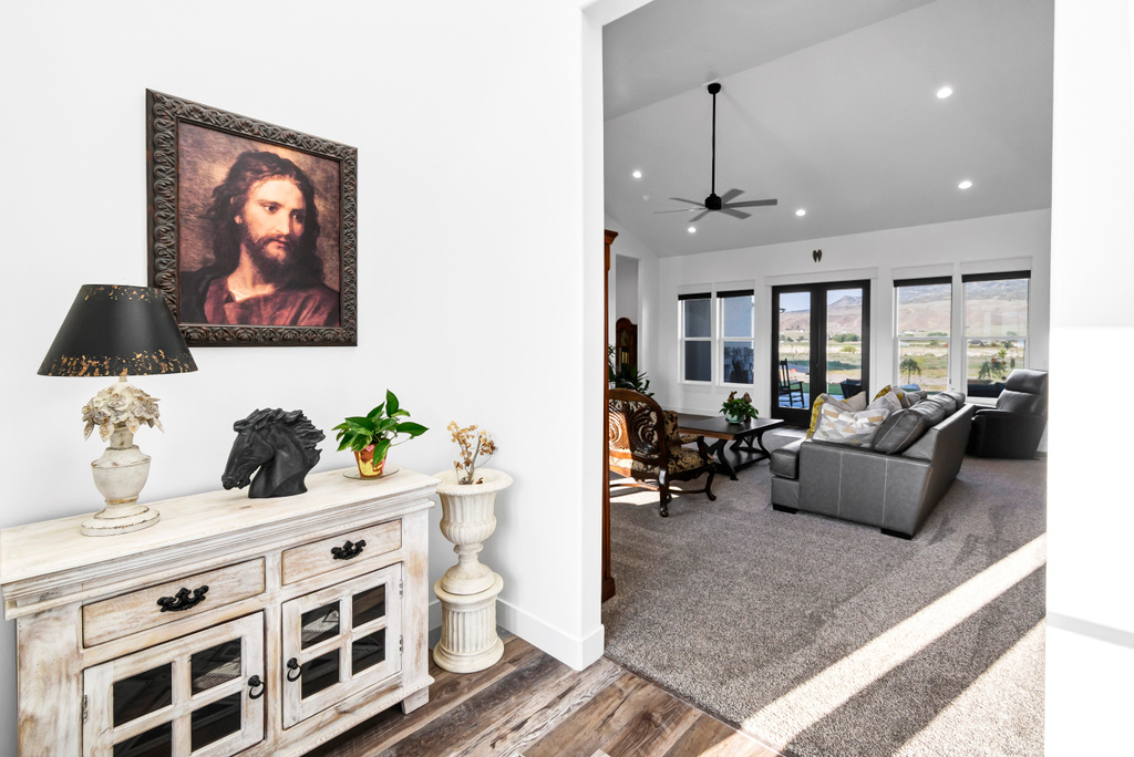 Living area featuring recessed lighting, wood finished floors, ceiling fan, and high vaulted ceiling