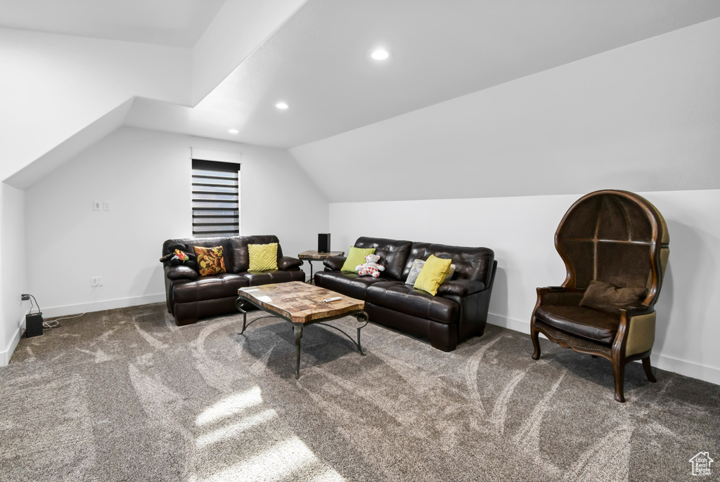 Living area featuring vaulted ceiling, carpet floors, and recessed lighting