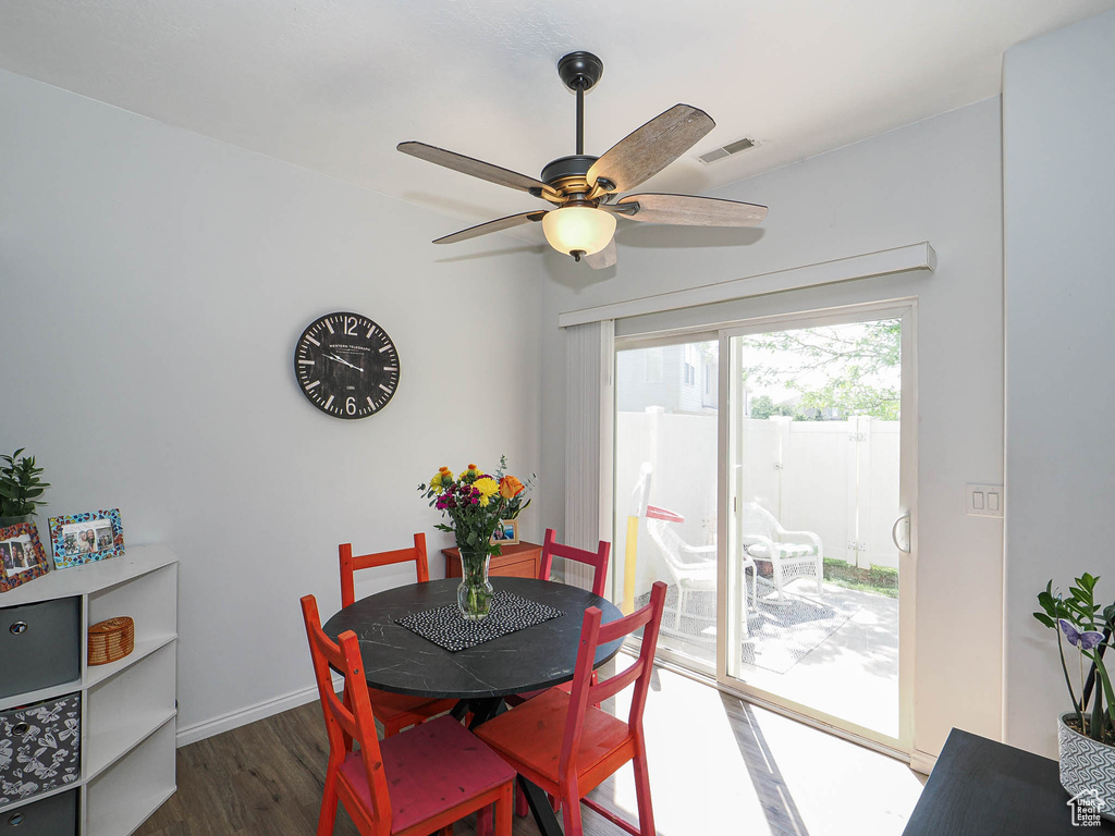 Dining room with wood finished floors and ceiling fan