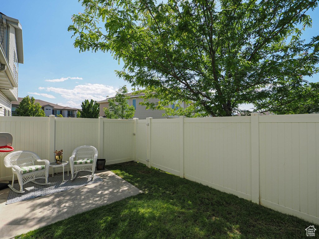 Fenced backyard featuring a patio