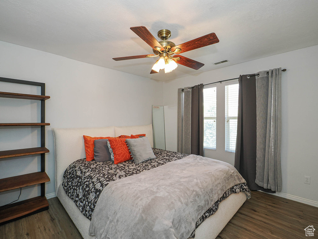 Bedroom with wood finished floors and ceiling fan