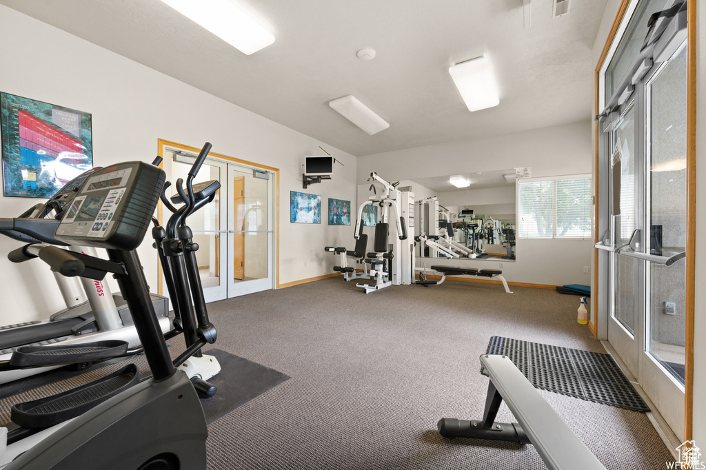 Exercise room with french doors and carpet flooring