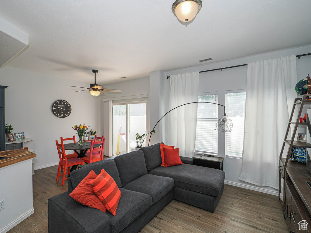 Living area with wood finished floors and ceiling fan