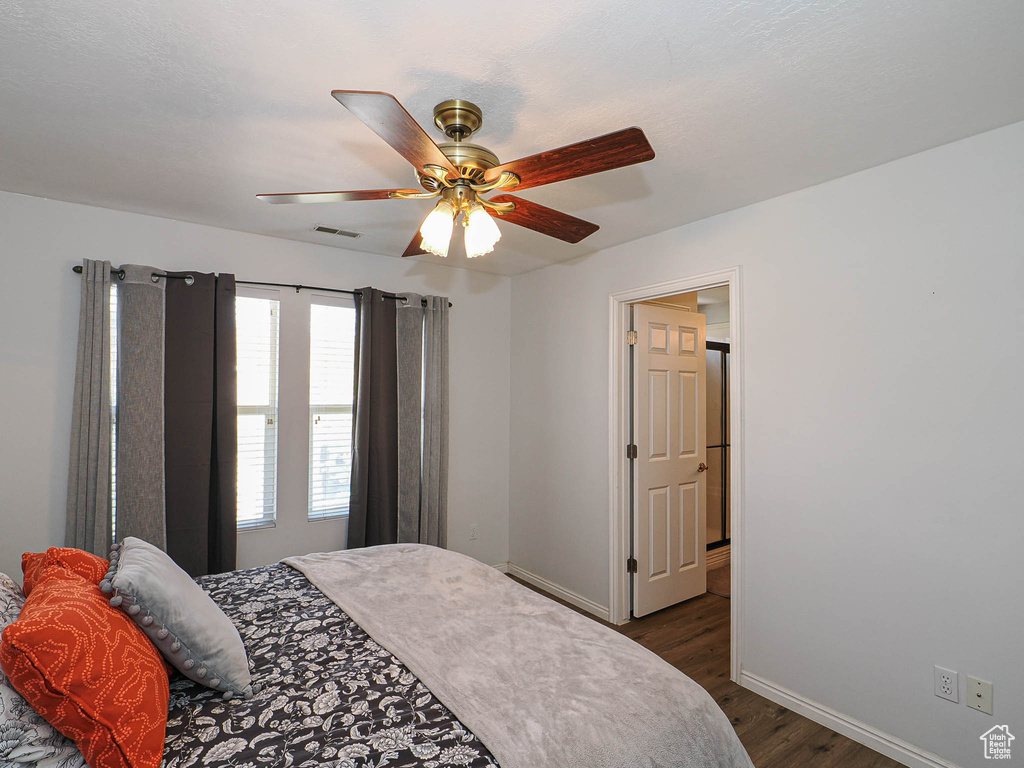 Bedroom with dark wood finished floors and ceiling fan