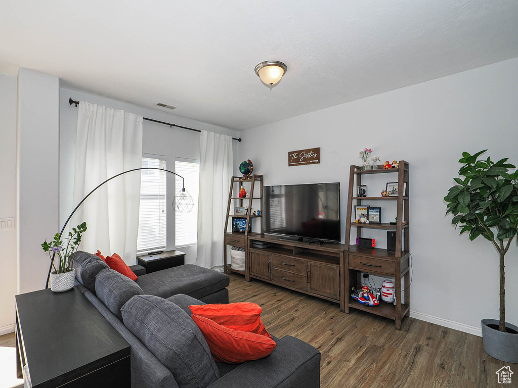 Living area featuring wood finished floors and baseboards