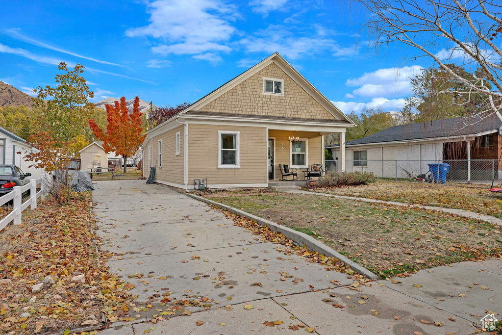 Bungalow-style house with covered porch and concrete driveway