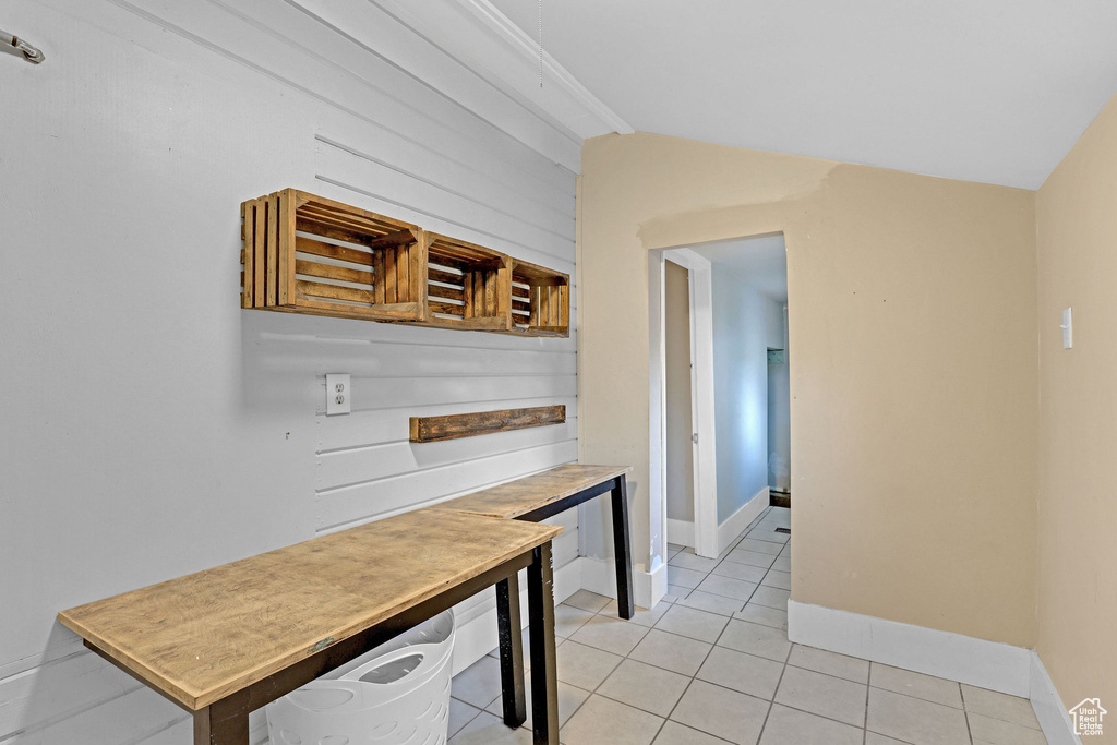 Kitchen featuring light tile patterned floors, vaulted ceiling, and open shelves
