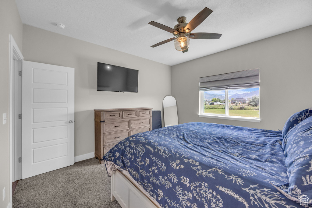 Bedroom featuring carpet and a ceiling fan