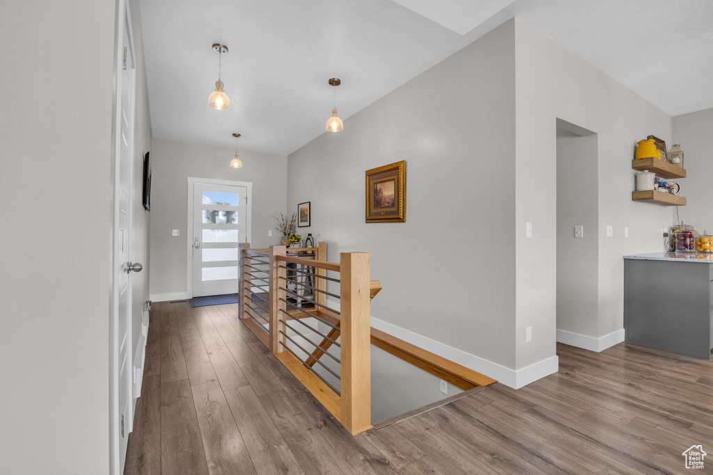 Hallway featuring wood finished floors and baseboards