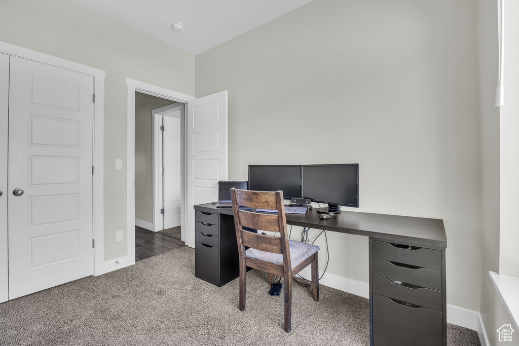 Carpeted home office with baseboards