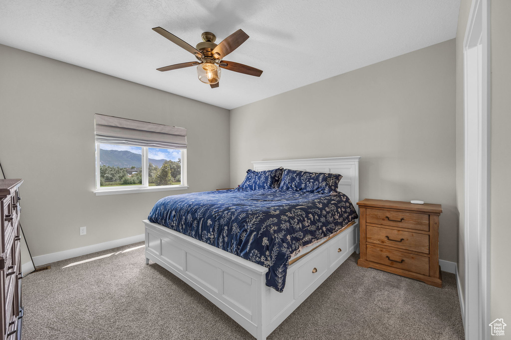 Bedroom with carpet flooring and a ceiling fan