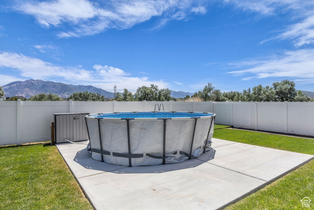View of swimming pool featuring a mountain view and a fenced backyard