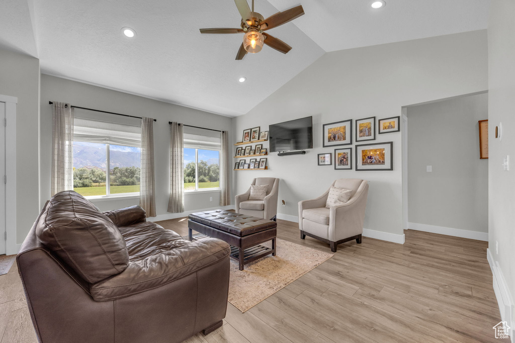 Living area featuring ceiling fan, recessed lighting, light wood-type flooring, and high vaulted ceiling