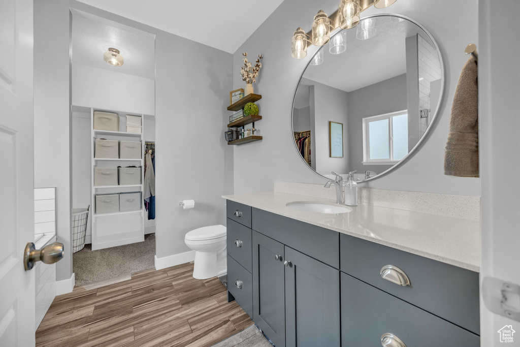 Full bathroom with vanity and wood finished floors