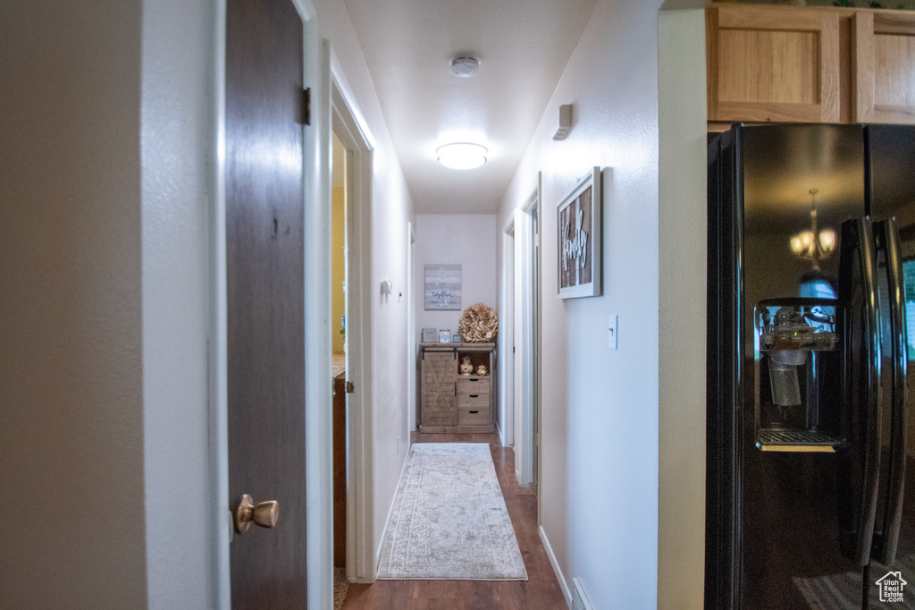 Corridor featuring wood finished floors and baseboards