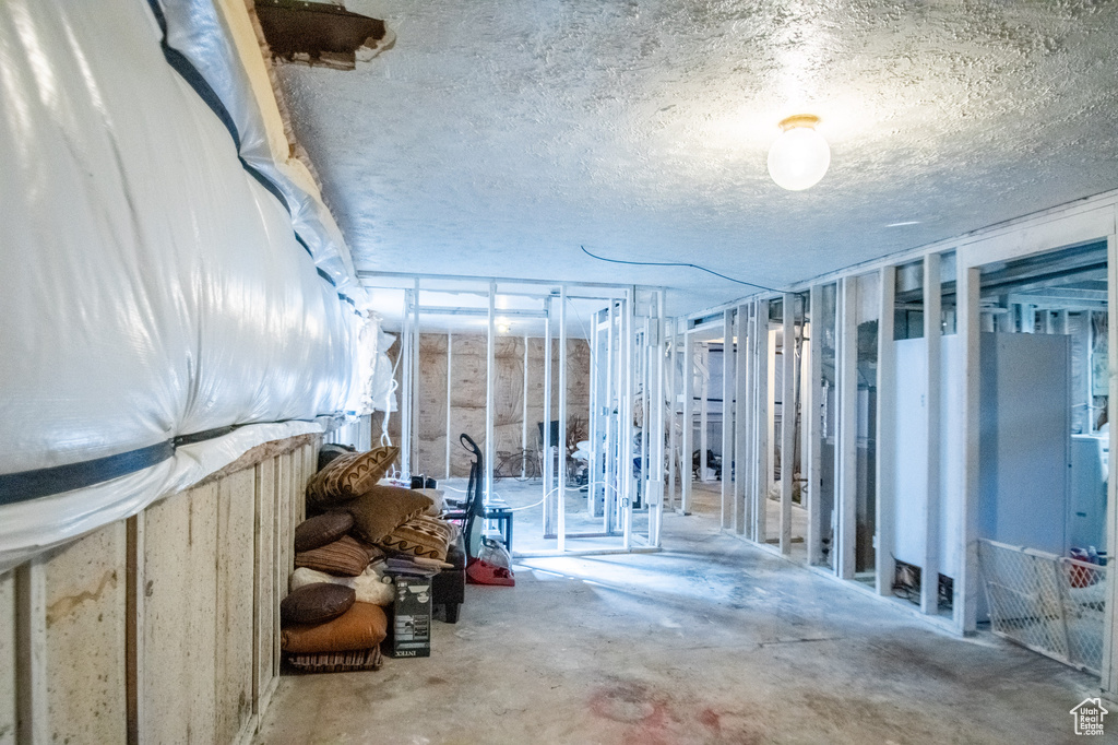Basement featuring a textured ceiling