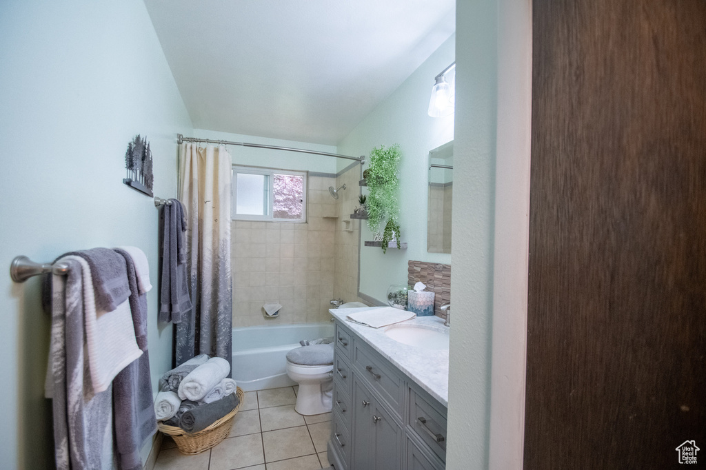 Full bathroom featuring vanity, shower / bath combination with curtain, and tile patterned floors
