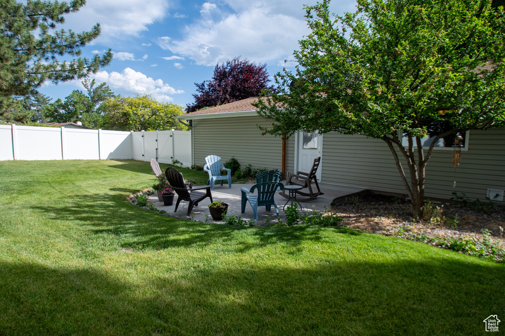 Fenced backyard with a patio