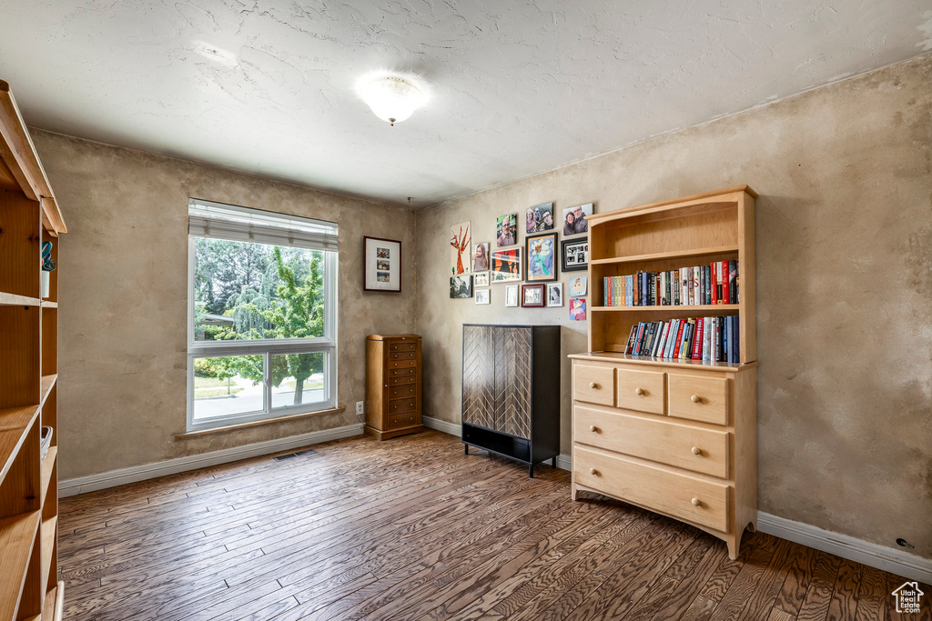 Office area with hardwood / wood-style floors and baseboards