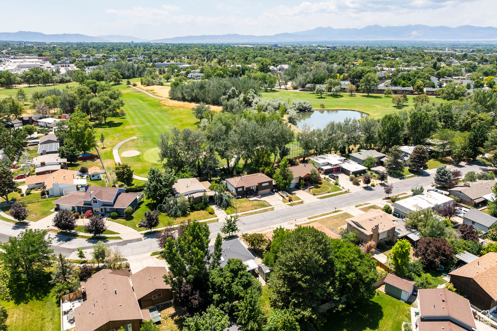 Aerial view of residential area with a golf club and a water and mountain view